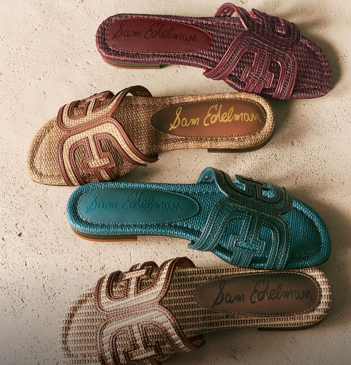 Four Sam Edelman Bay Slide Sandals in Brick Se, Twany Tan, Cafe Sand, and Pacific Teal faux raffia.