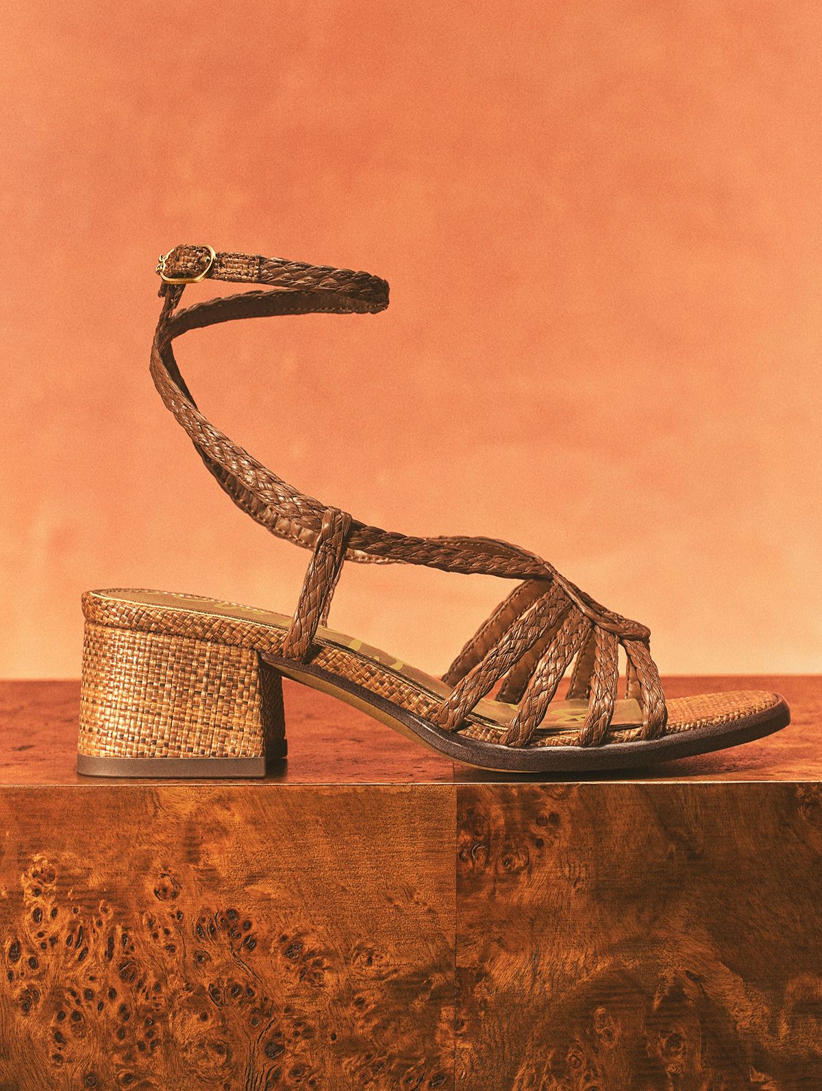 Brown Fletcher block heel sandal featuring braided ankle straps and a textured woven heel.
