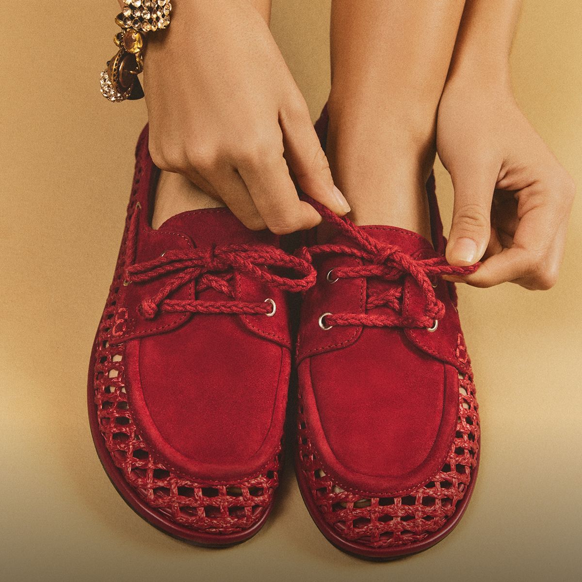 Red Bria woven lace-up loafers highlighting the suede detailing and braided laces being tied.