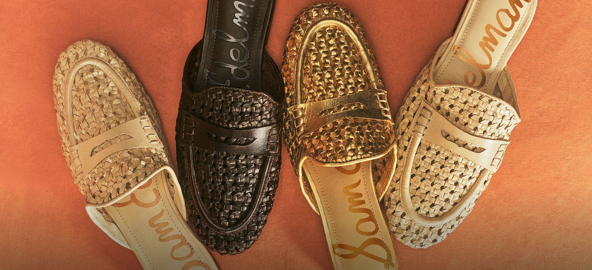 A close-up of Tullie woven leather mules in shades of ivory, black, and gold